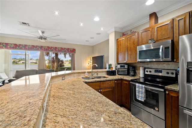 kitchen featuring stainless steel appliances, sink, ceiling fan, crown molding, and backsplash