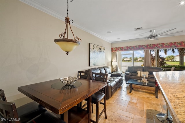 dining area featuring ceiling fan and ornamental molding