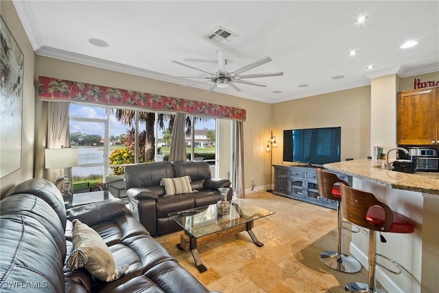 living room with ceiling fan, crown molding, and sink