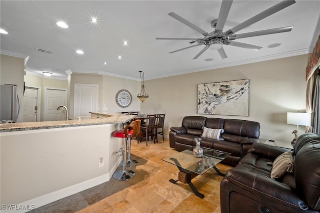 living room with ceiling fan, sink, and ornamental molding