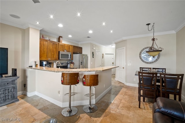 kitchen with ornamental molding, kitchen peninsula, and stainless steel appliances