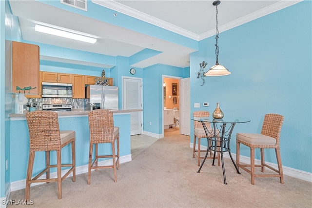 kitchen with tasteful backsplash, kitchen peninsula, light carpet, and stainless steel appliances