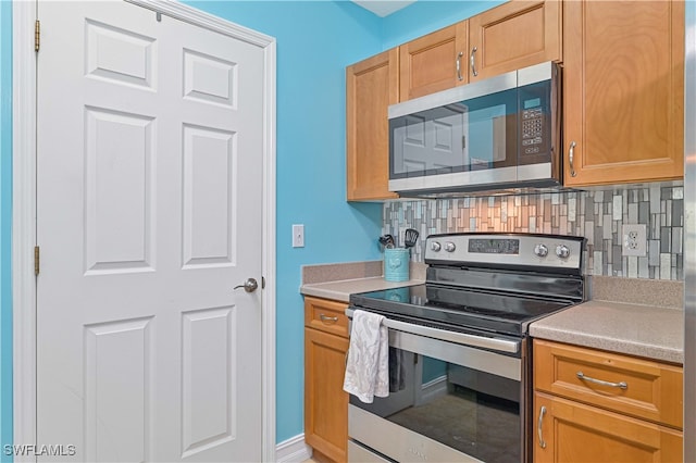 kitchen with stainless steel appliances and tasteful backsplash