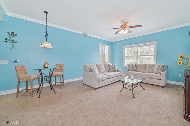 carpeted living room featuring ceiling fan and crown molding