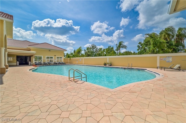 view of swimming pool featuring a patio area