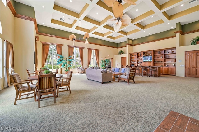 living room with coffered ceiling, carpet flooring, ceiling fan, and a towering ceiling