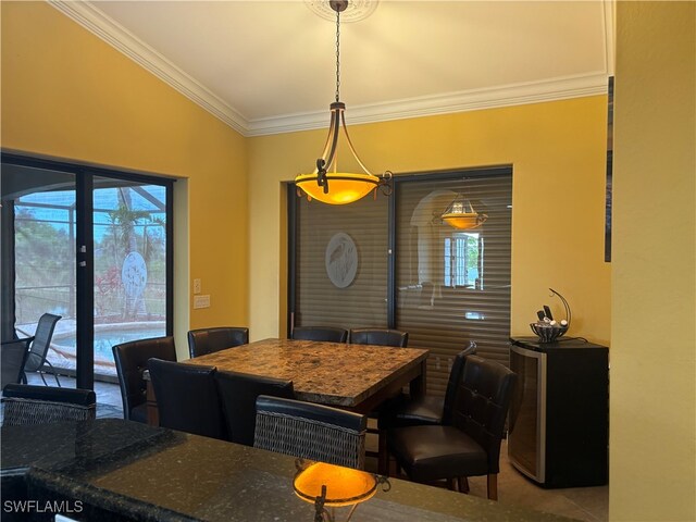 dining room with a wealth of natural light, tile patterned floors, and ornamental molding