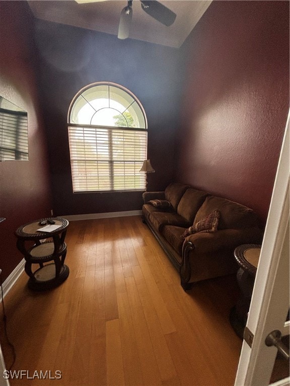 living room featuring hardwood / wood-style flooring and ceiling fan