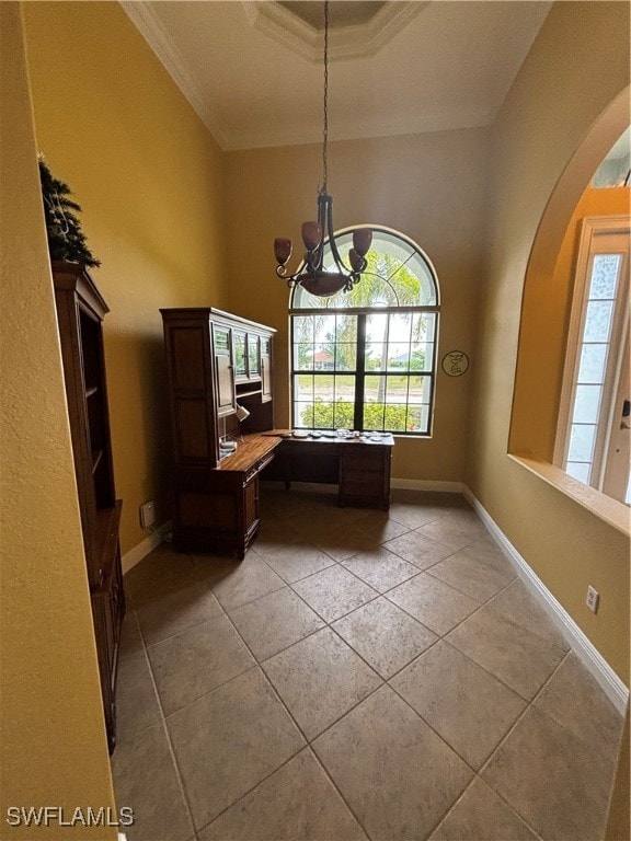 interior space with ornamental molding, a wealth of natural light, a notable chandelier, and light tile patterned floors