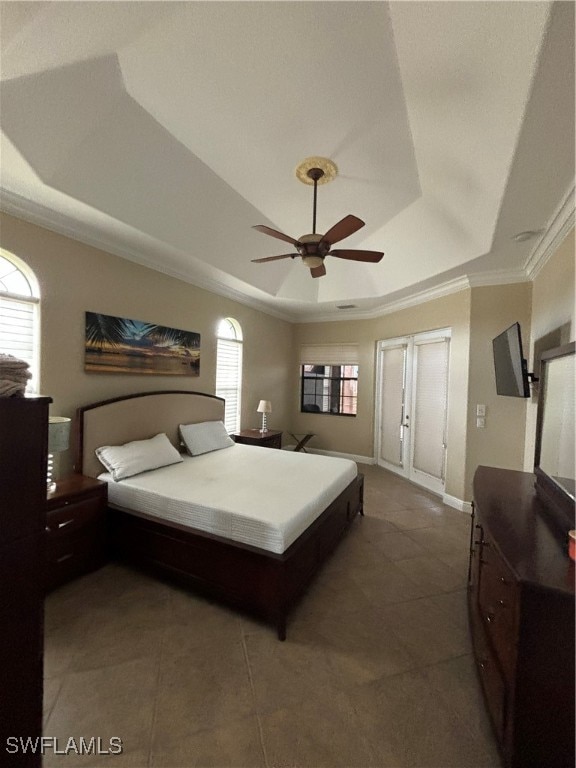 bedroom with ornamental molding, a tray ceiling, and ceiling fan