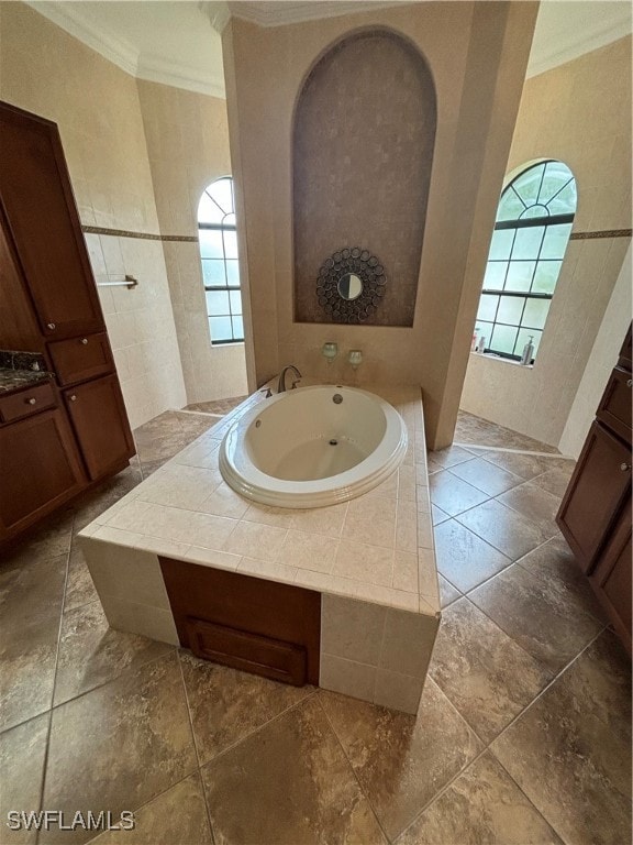 bathroom featuring vanity, a washtub, and ornamental molding