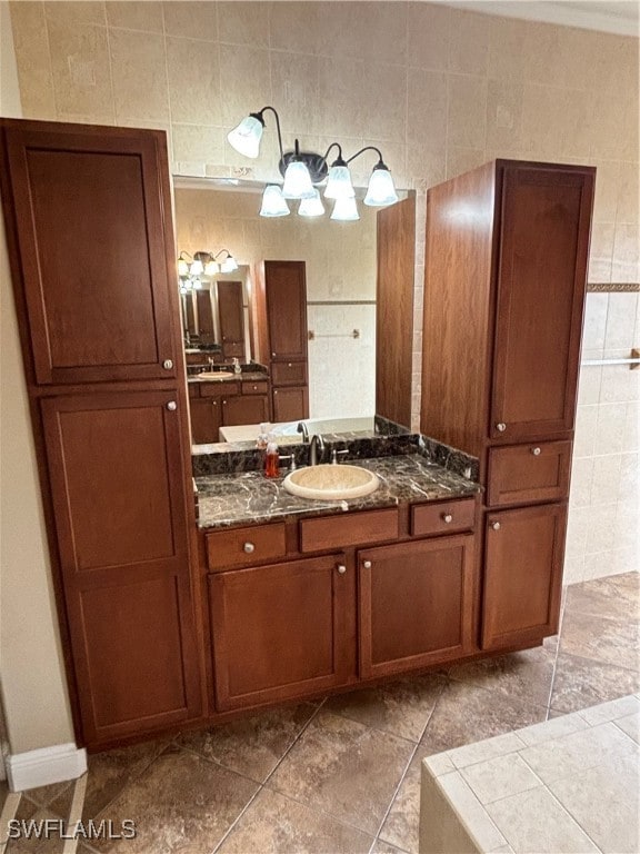 bathroom featuring tile walls, tile patterned flooring, and vanity