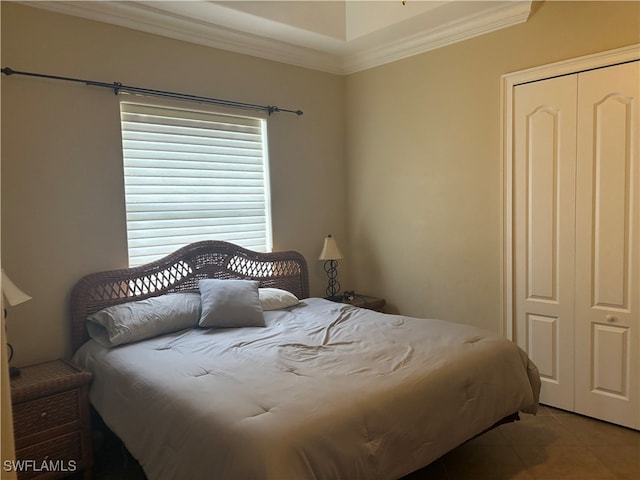 bedroom with ornamental molding, tile patterned flooring, and a closet