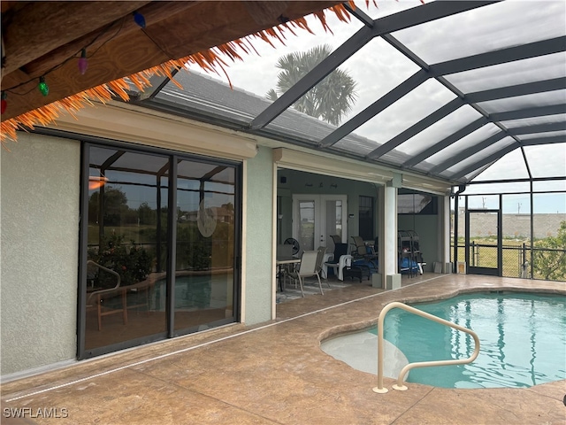 view of swimming pool with a lanai and a patio