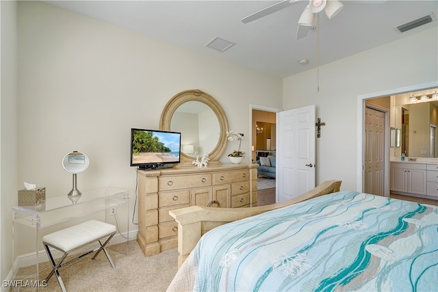 carpeted bedroom featuring ensuite bath and ceiling fan