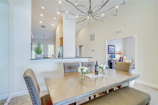 dining space featuring a high ceiling and light tile patterned floors