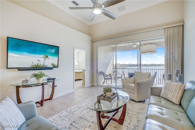 living room with a water view, light tile patterned flooring, and ceiling fan