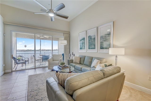 tiled living room featuring a water view, ceiling fan, and crown molding