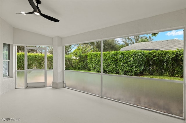 unfurnished sunroom featuring lofted ceiling and ceiling fan