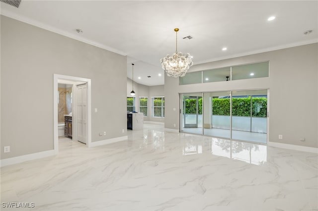 spare room with a chandelier and crown molding