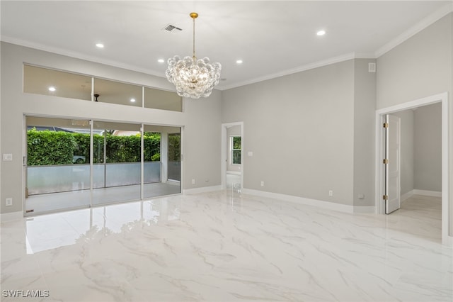 spare room with a high ceiling, an inviting chandelier, and ornamental molding