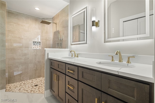 bathroom featuring vanity and tiled shower