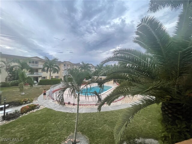 view of swimming pool featuring a patio area and a lawn