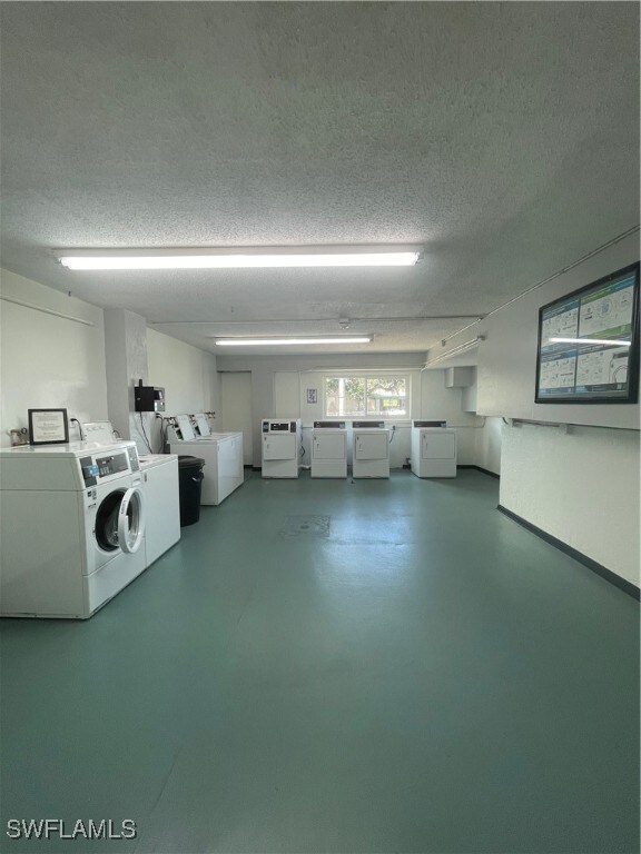 laundry room featuring independent washer and dryer and a textured ceiling