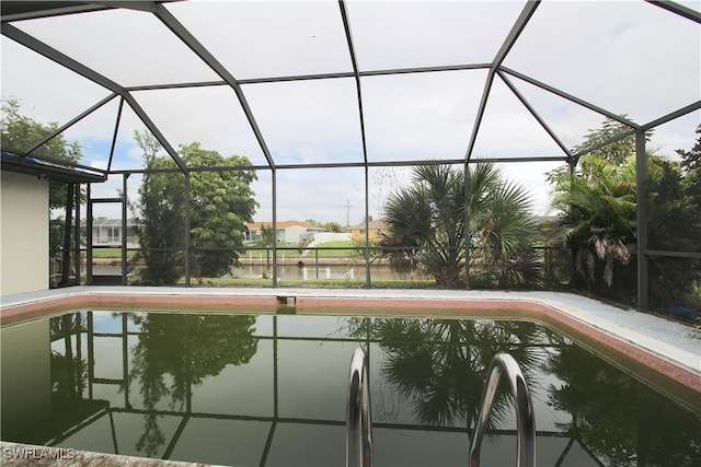 view of swimming pool with a lanai and a water view