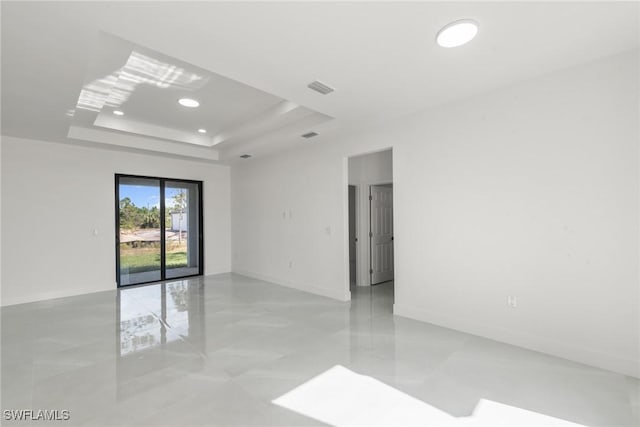 unfurnished room with a tray ceiling