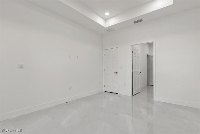 unfurnished room with a raised ceiling