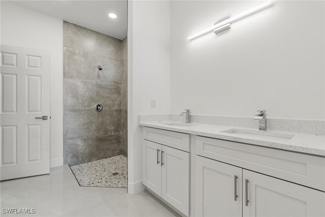 bathroom with vanity and a tile shower