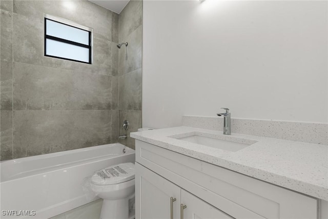 full bathroom featuring toilet, vanity, and tiled shower / bath