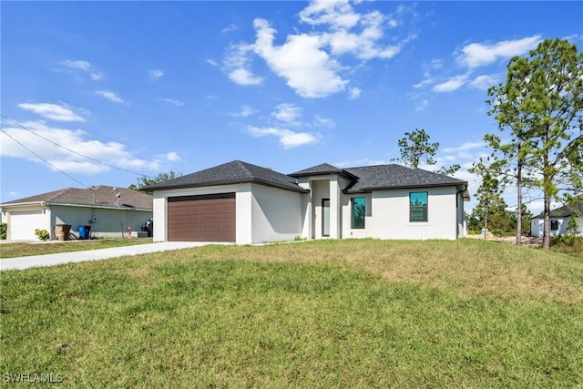 prairie-style home with a front yard and a garage