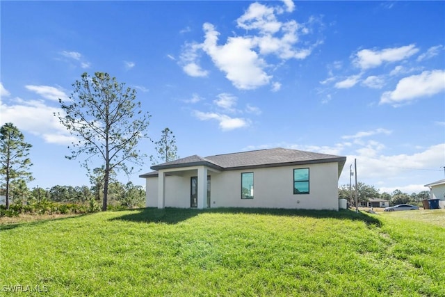 back of house with a lawn