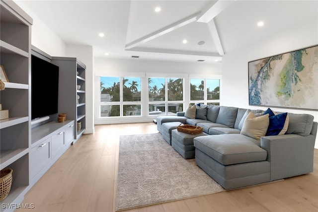 living room featuring light wood-type flooring and beamed ceiling