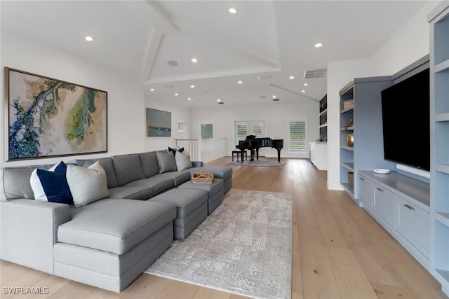 living room with lofted ceiling and light hardwood / wood-style floors