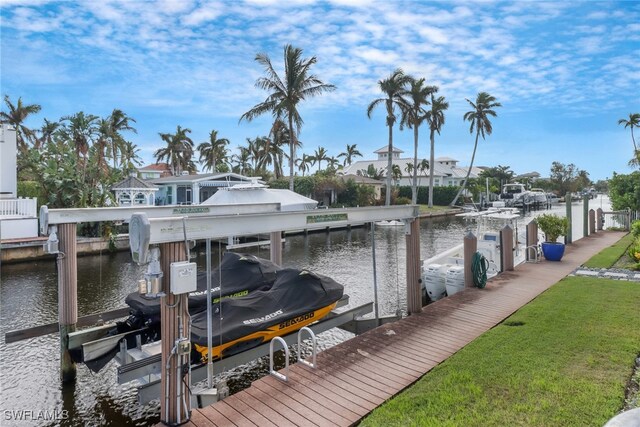 dock area with a water view and a lawn