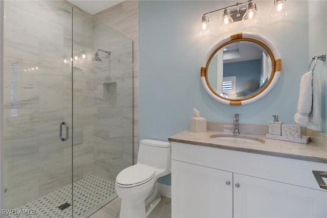 bathroom featuring a shower with shower door, vanity, toilet, and tile patterned floors