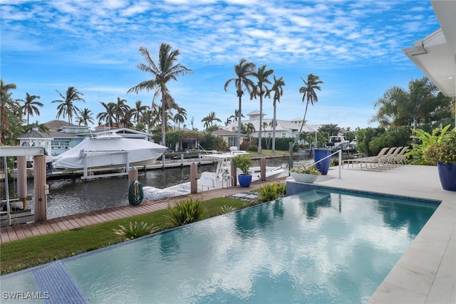 view of pool with a dock and a water view