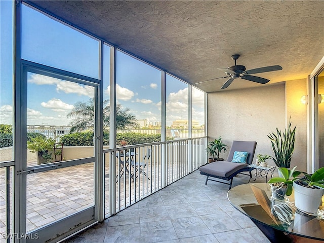 sunroom with plenty of natural light and ceiling fan