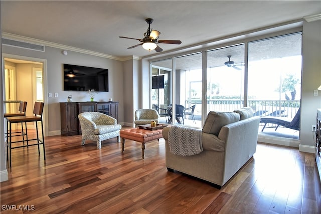 living room with ceiling fan, dark hardwood / wood-style flooring, and ornamental molding