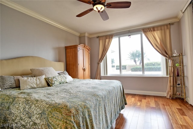 bedroom featuring ceiling fan, light hardwood / wood-style flooring, and crown molding