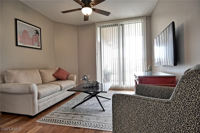 living room with hardwood / wood-style flooring and ceiling fan