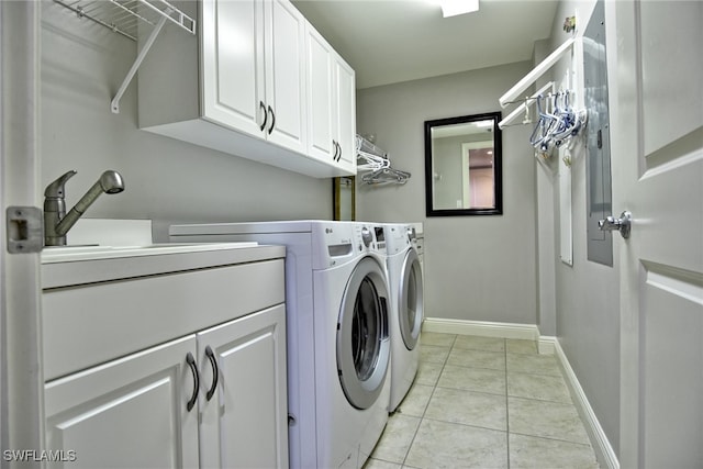 washroom featuring light tile patterned floors, cabinets, and independent washer and dryer