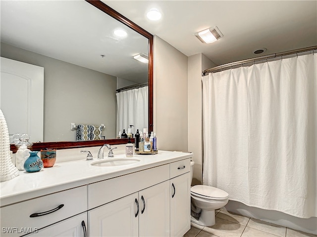 bathroom with tile patterned flooring, vanity, and toilet