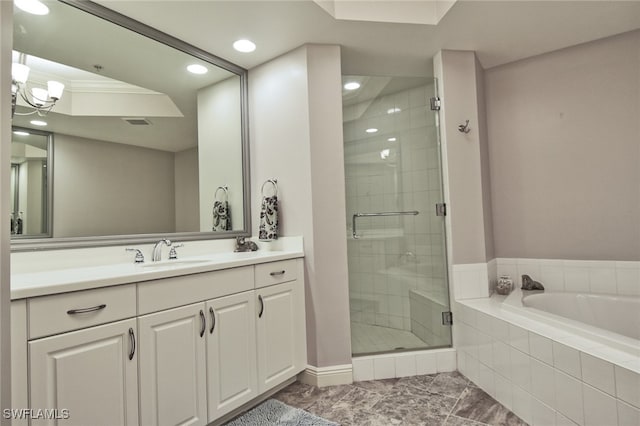 bathroom featuring an inviting chandelier, vanity, and shower with separate bathtub