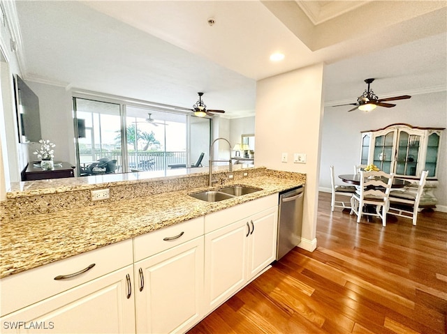 kitchen featuring dishwasher, sink, crown molding, dark hardwood / wood-style flooring, and white cabinetry