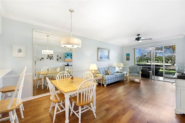 dining area with ornamental molding, hardwood / wood-style flooring, and ceiling fan