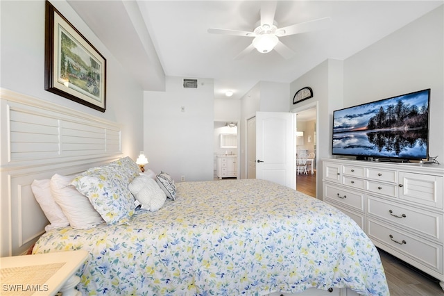 bedroom featuring hardwood / wood-style flooring, ensuite bath, and ceiling fan